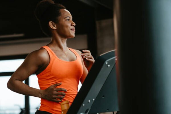 Woman jogging on treadmill in the gym